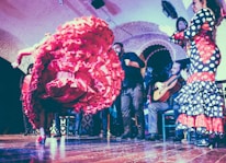 Close-up of flamenco dancer's hands clapping rhythmically with traditional bracelets.