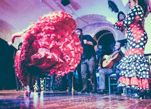 A lively flamenco dancer mid-spin with flowing red dress and expressive movement