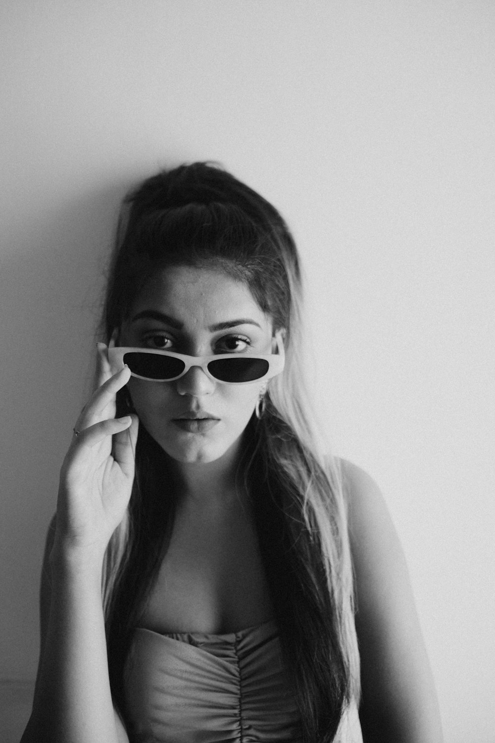 woman wearing sunglasses in grayscale photography