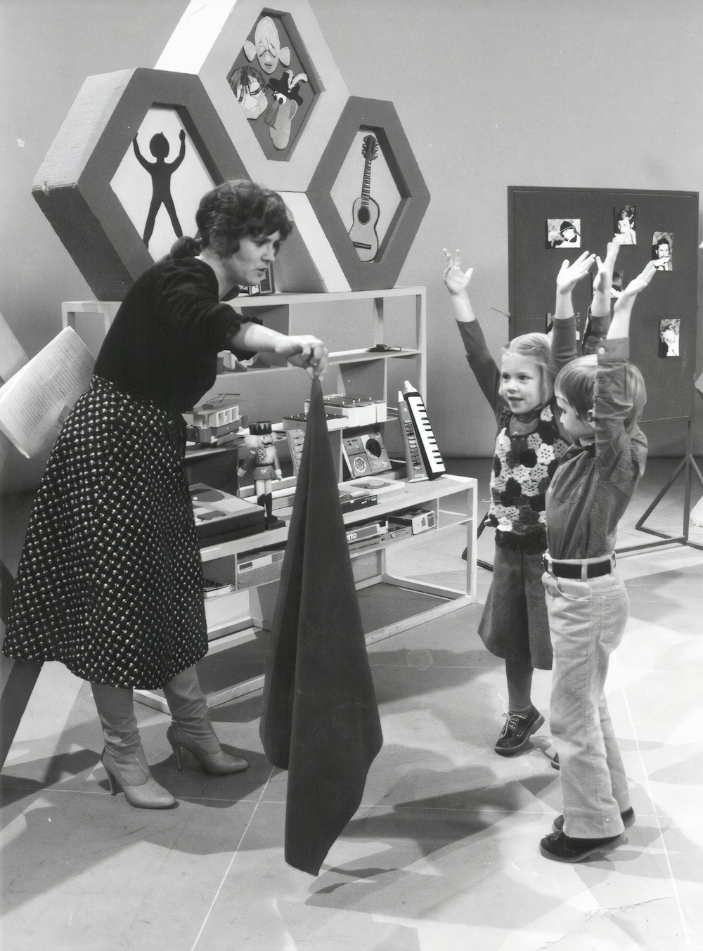 woman in polka dot dress standing beside man in black and white polka dot shirt