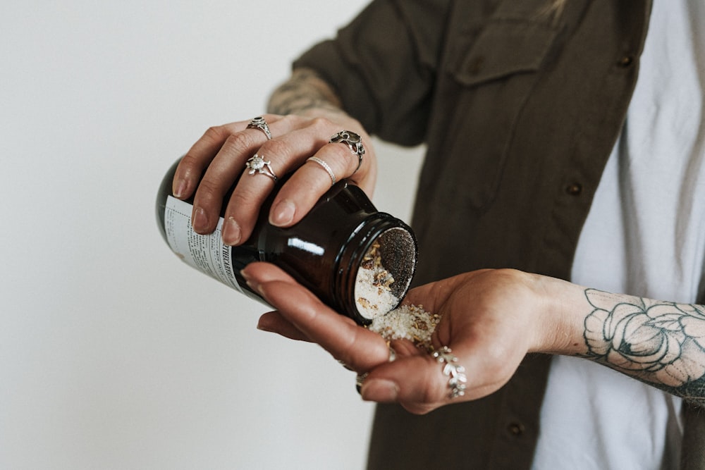 person holding black ceramic mug