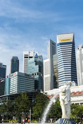 white horse statue near high rise buildings during daytime