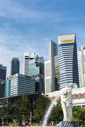 white horse statue near high rise buildings during daytime