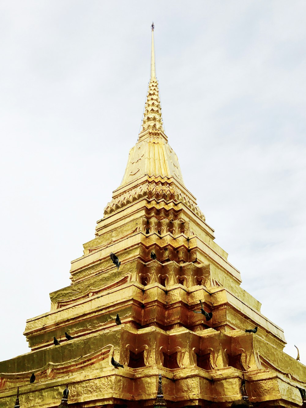 gold tower under white clouds