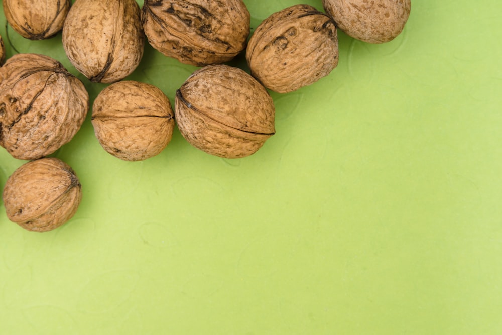 brown round fruits on green surface