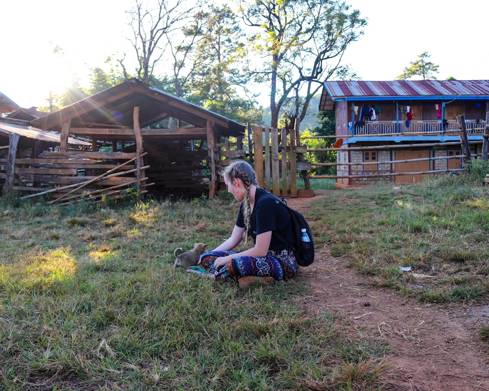 man in blue t-shirt sitting on brown wooden bench