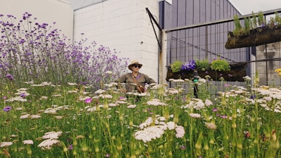 woman in brown coat sitting on green grass field
