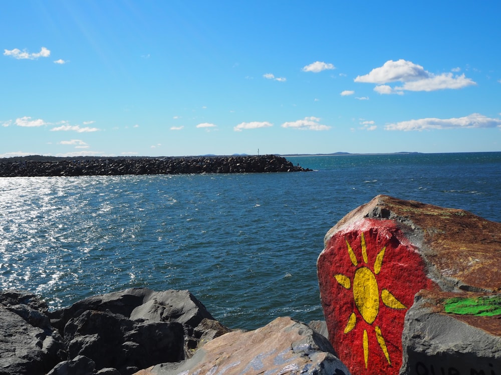 brown rock formation near body of water during daytime