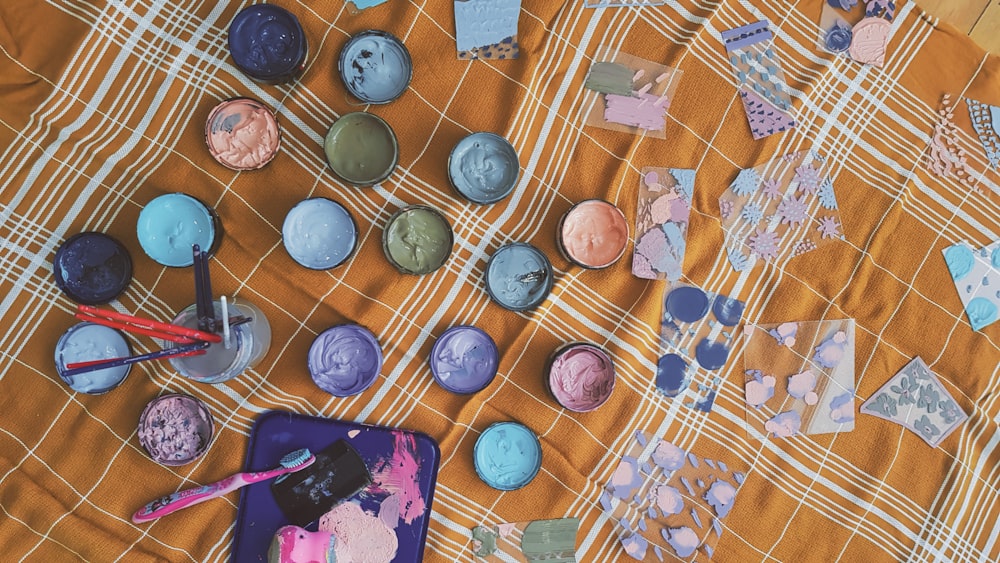 assorted coins on white and brown textile