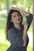 A model wearing relaxed clothing in a tranquil setting.