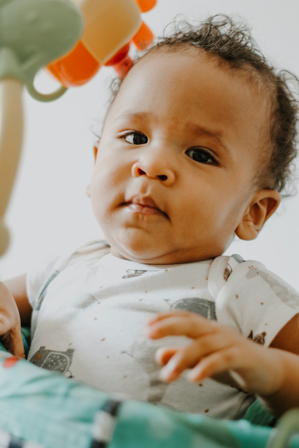 baby in white and gray onesie