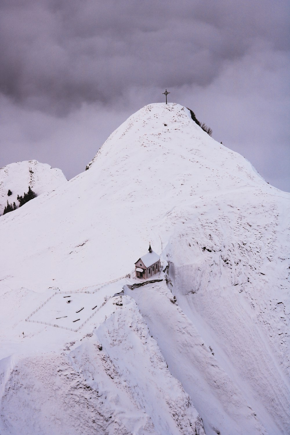 white and brown house on snow covered mountain