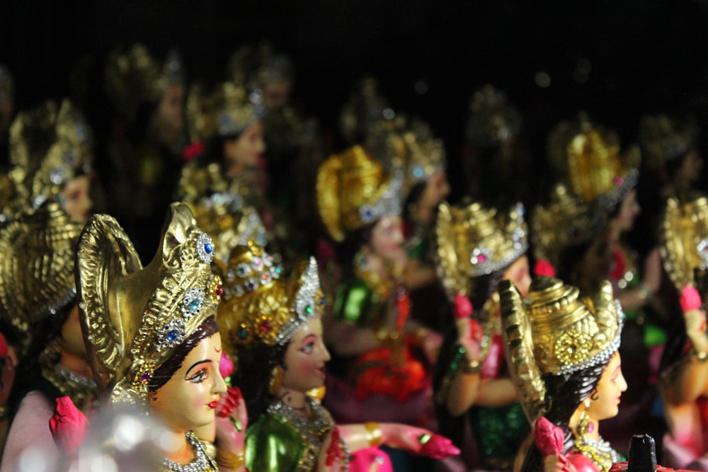 people wearing gold and purple headdress