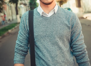 man in blue sweater wearing black sunglasses