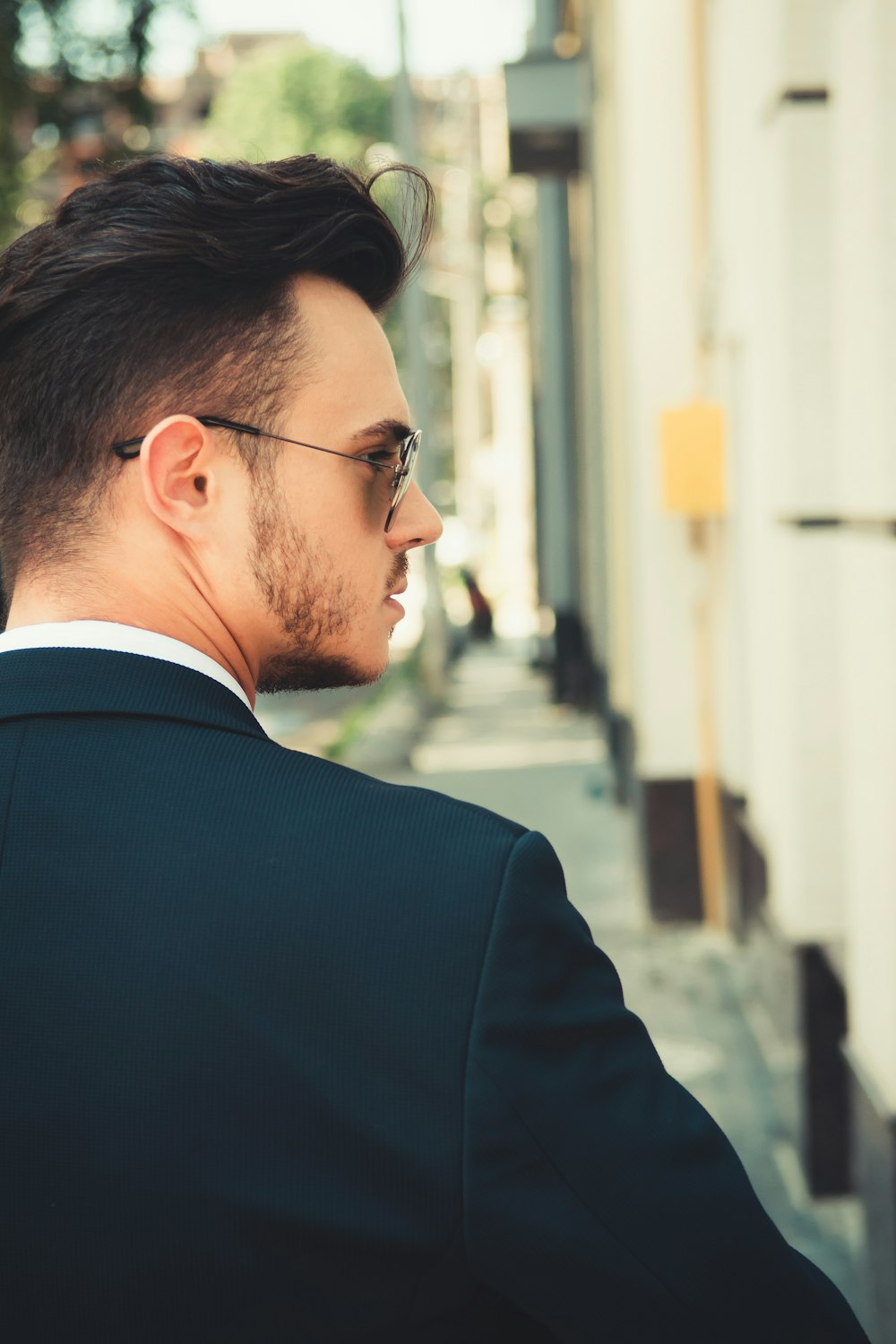 man in black suit wearing eyeglasses