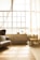 A beautifully staged living room with natural light streaming through large windows.
