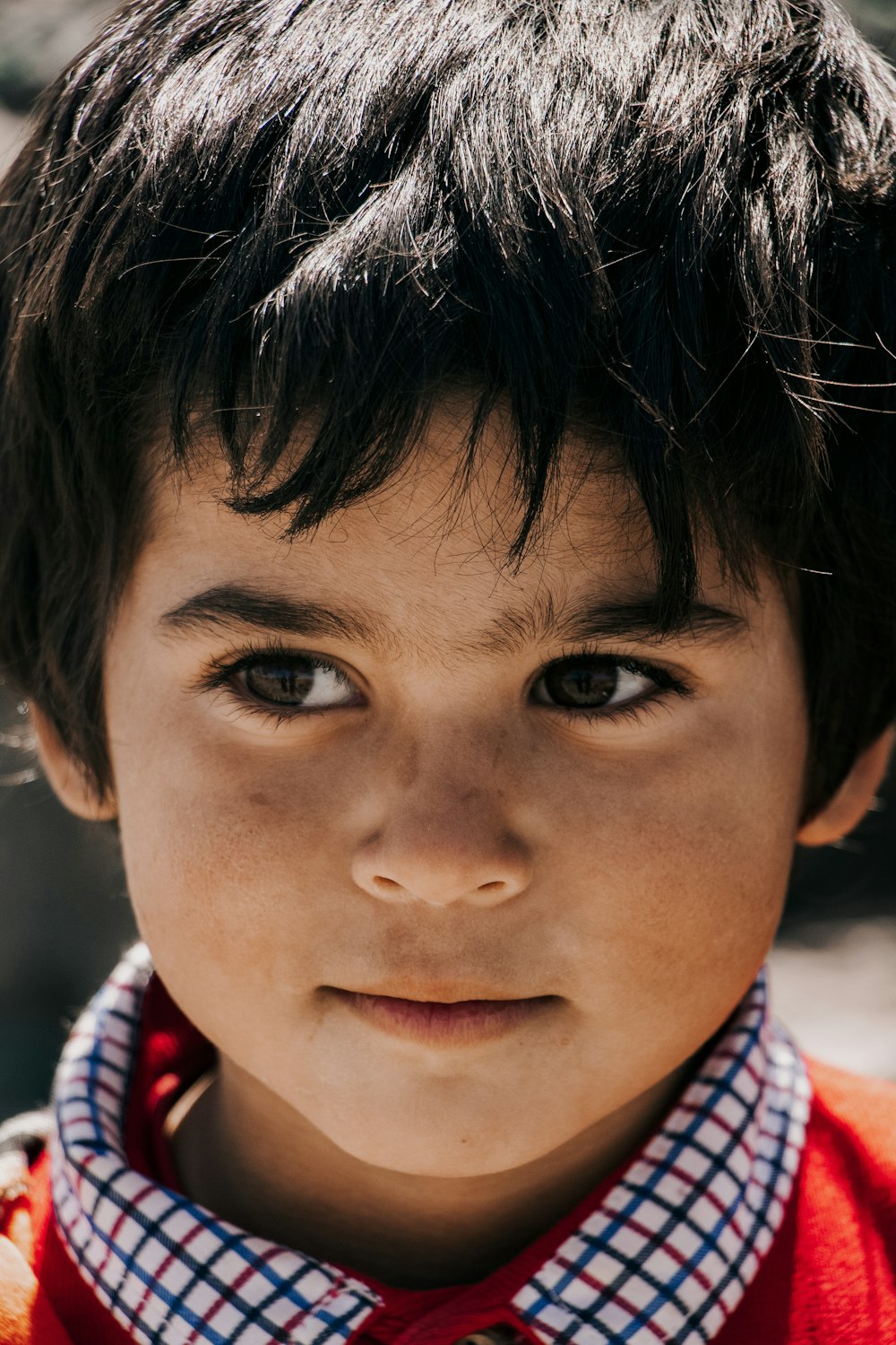 boy in red white and blue plaid shirt