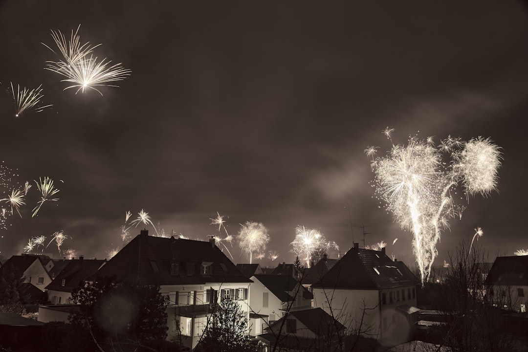 fireworks display over houses during night time