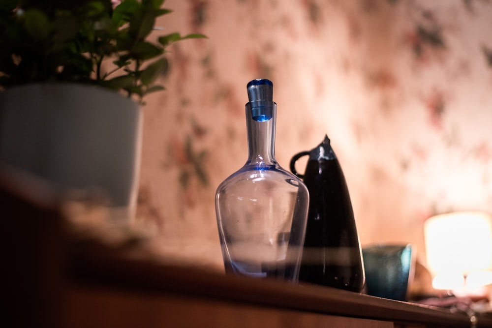 clear glass bottle on brown wooden table