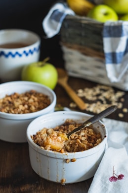 white ceramic bowl with brown rice and stainless steel spoon