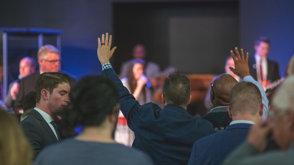 man in black long sleeve shirt raising his hands