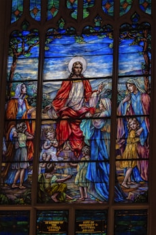 A colorful drawing of children gathered around a storyteller, with illustrated Bible story characters around them.