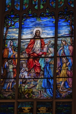 A beautiful depiction of Jesus surrounded by small children, illustrating love and care.