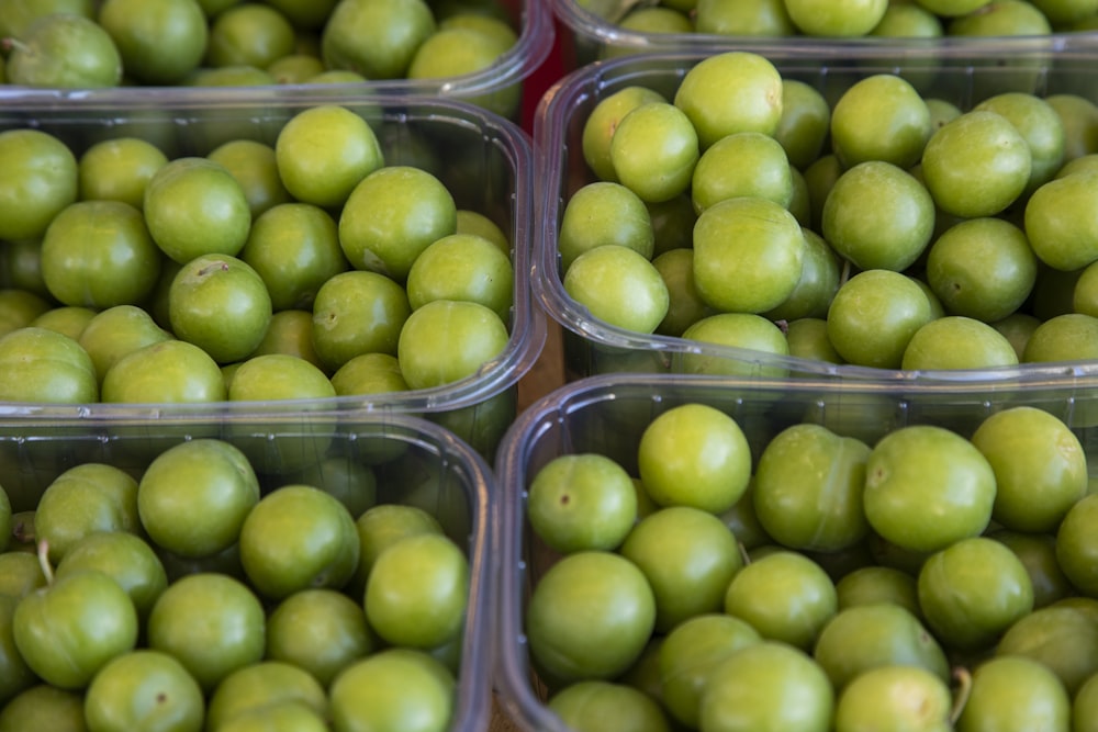 green round fruits in plastic container