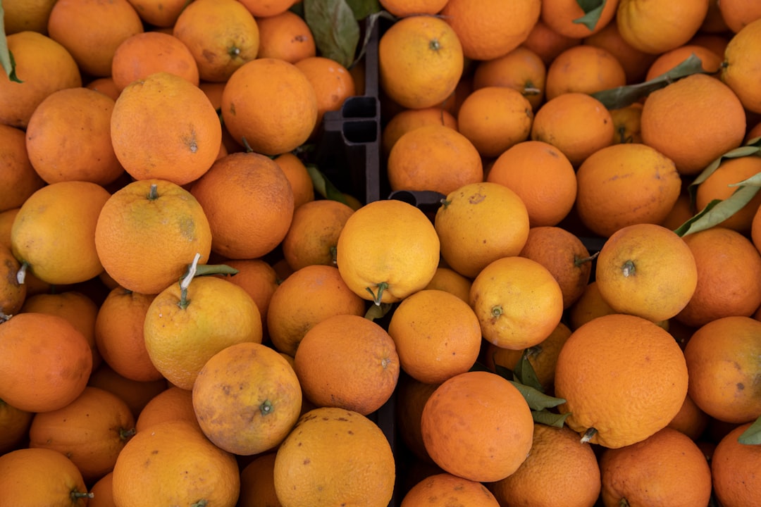 orange fruits on black plastic crate