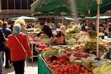 Visitors exploring local produce at a market.