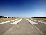 Wide-angle view of the runway with bold typography projected in the background and a captivated audience.