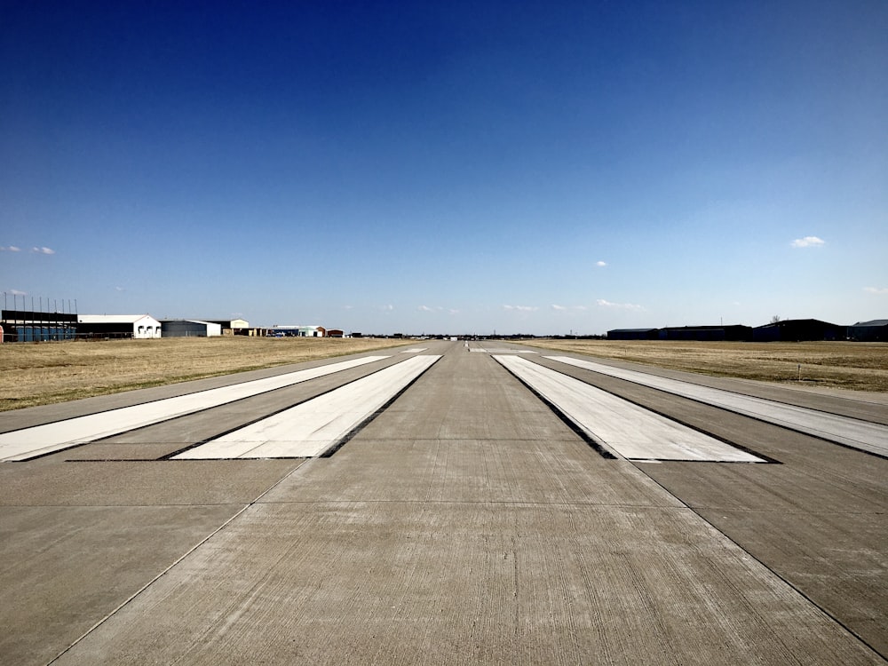 gray asphalt road under blue sky during daytime