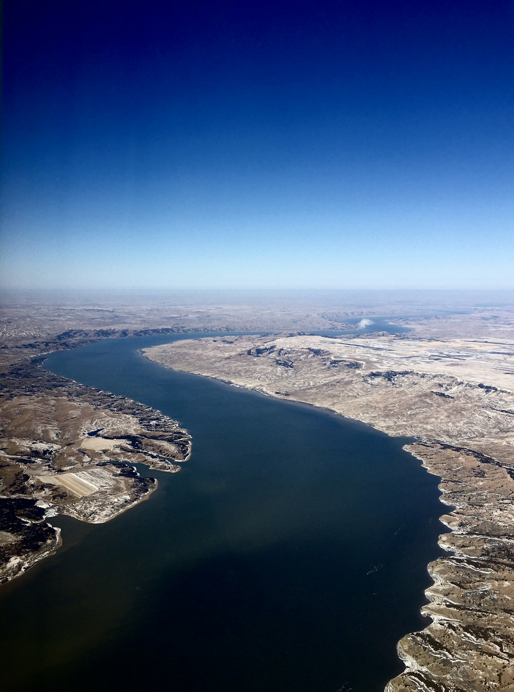 aerial view of lake and mountains during daytime
