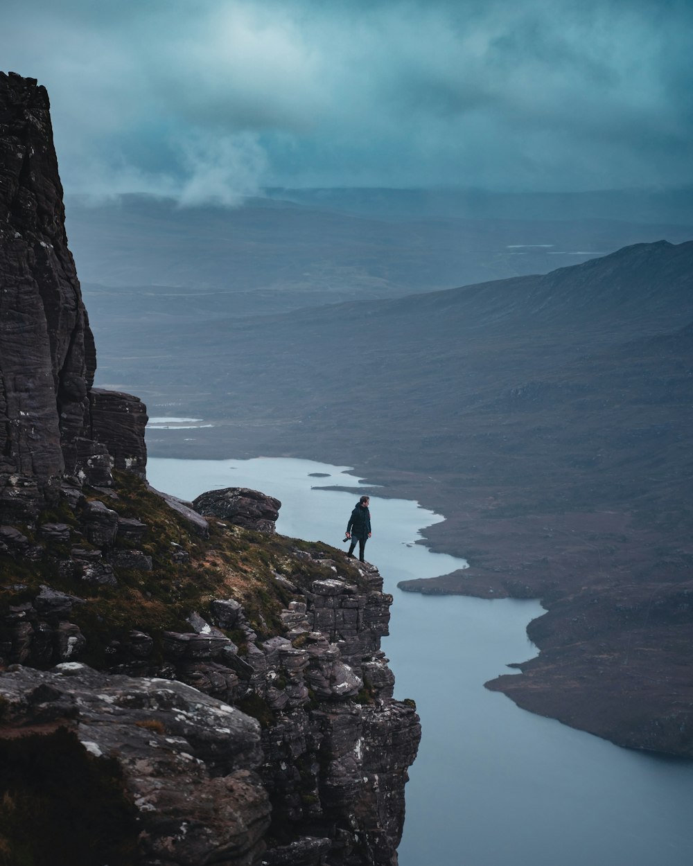 Person standing on rock formation near body of water during daytime photo –  Free Nature Image on Unsplash