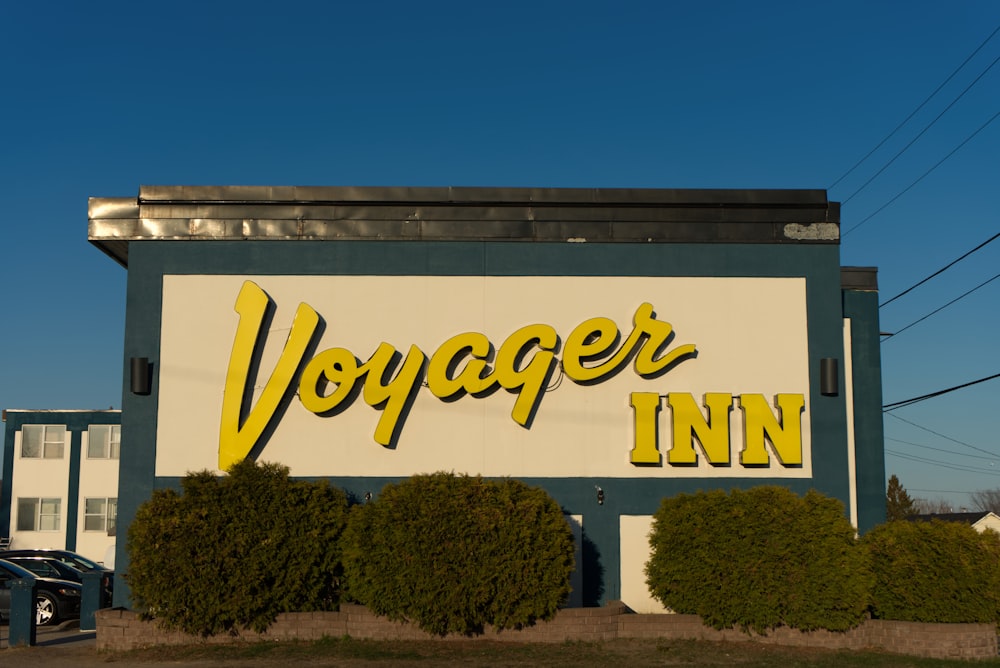 a large sign that says voyager inn on the side of a building