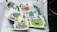 A collection of cartoonish and vibrant stickers featuring various humorous and playful characters, including a caveman with a cigar, smiling green creatures, and quirky designs. Each sticker is colorful and arranged in a casual, overlapping manner on a surface.