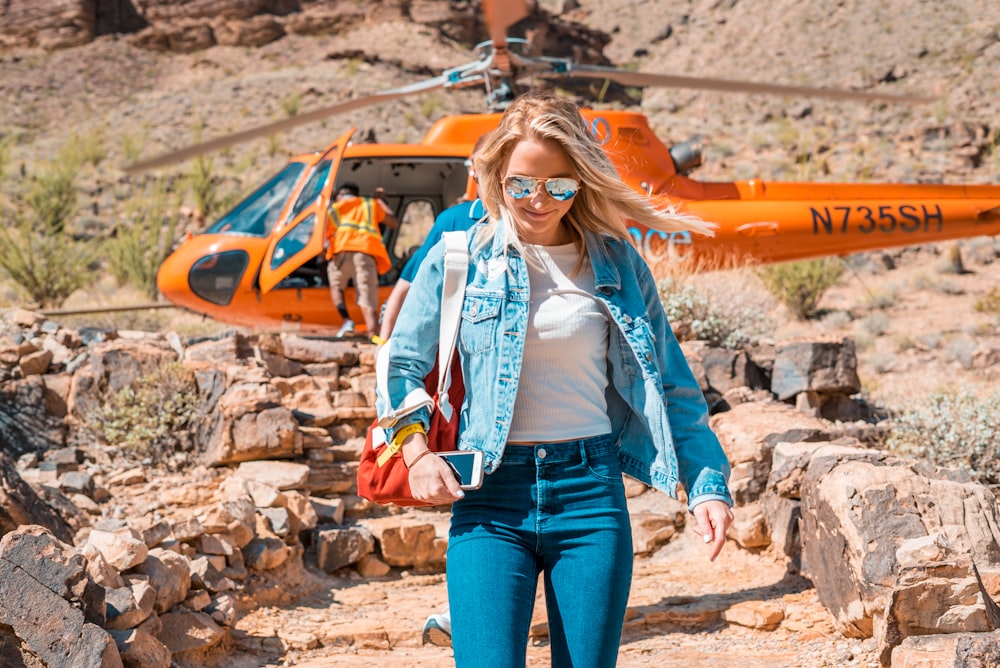 woman in blue denim jacket and blue denim jacket standing on rocky ground during daytime