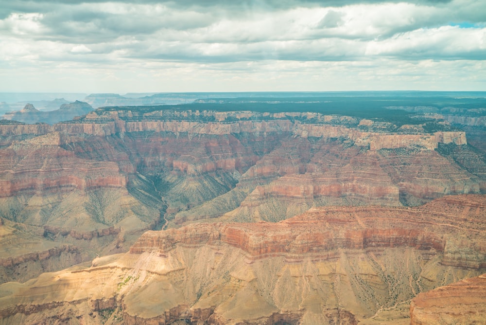 brown rock formation under white clouds during daytime