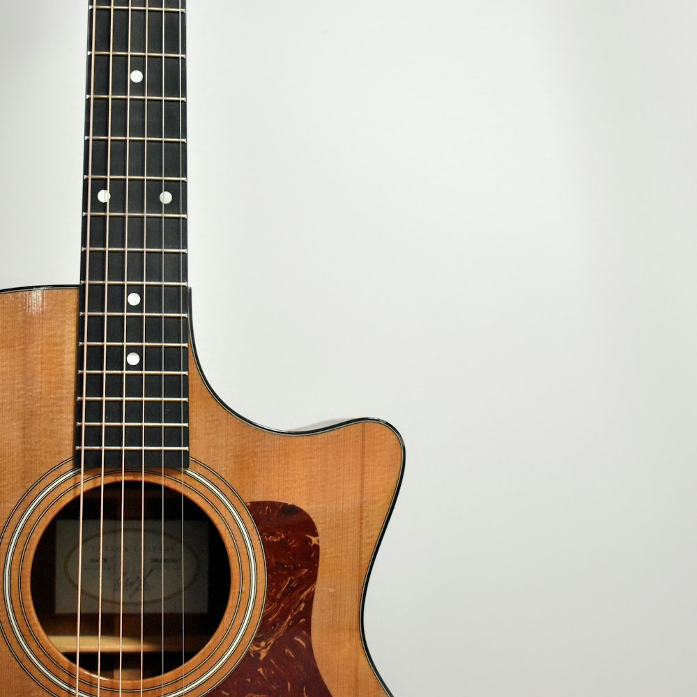 brown acoustic guitar on white background