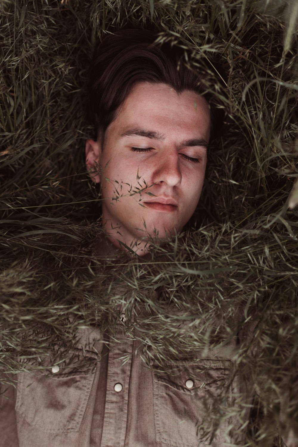 man lying on green grass