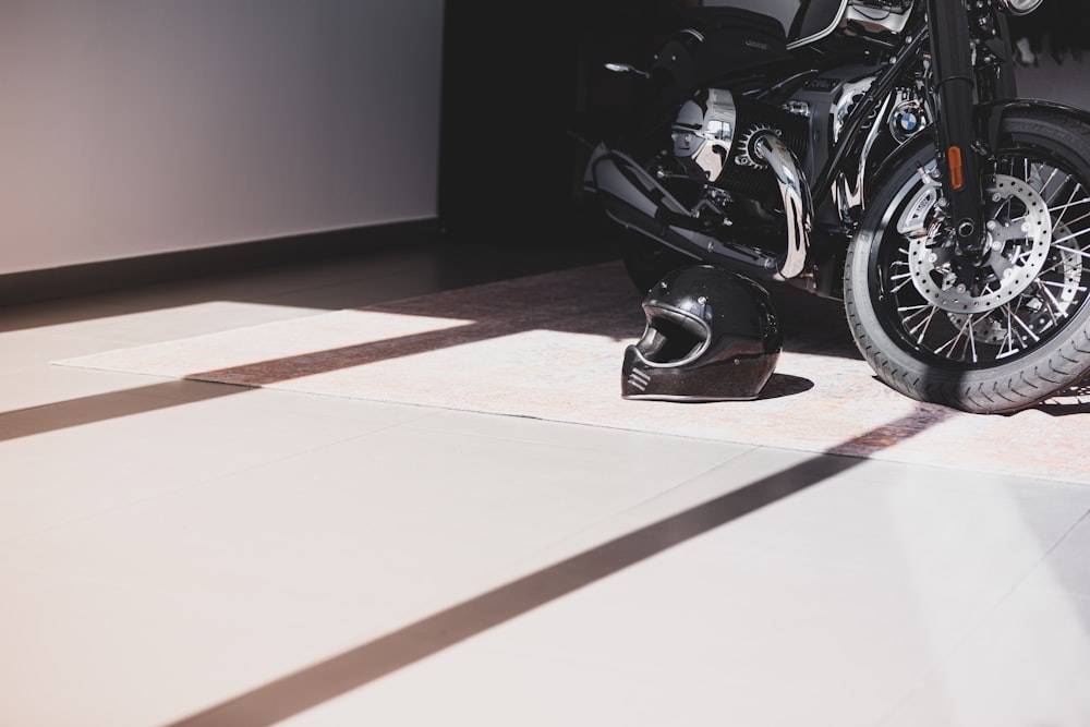 black motorcycle parked on brown floor