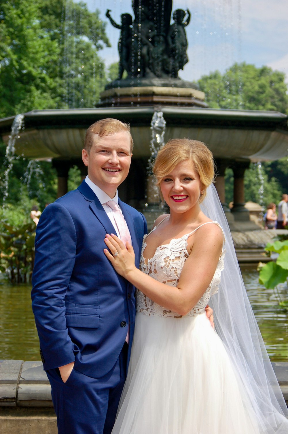 man in blue suit jacket beside woman in white wedding dress