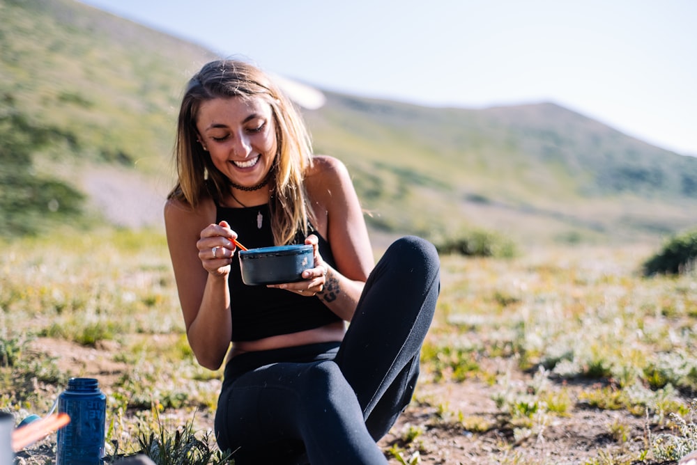 Young woman sitting on the grass and smiling 