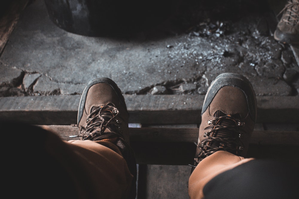 person in brown pants and brown leather shoes