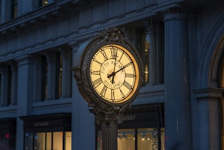 brown and white analog clock at 11 00