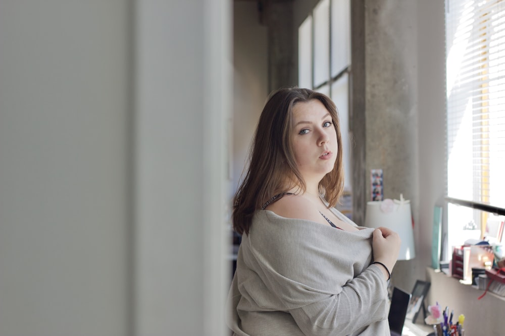 woman in white long sleeve shirt sitting on chair