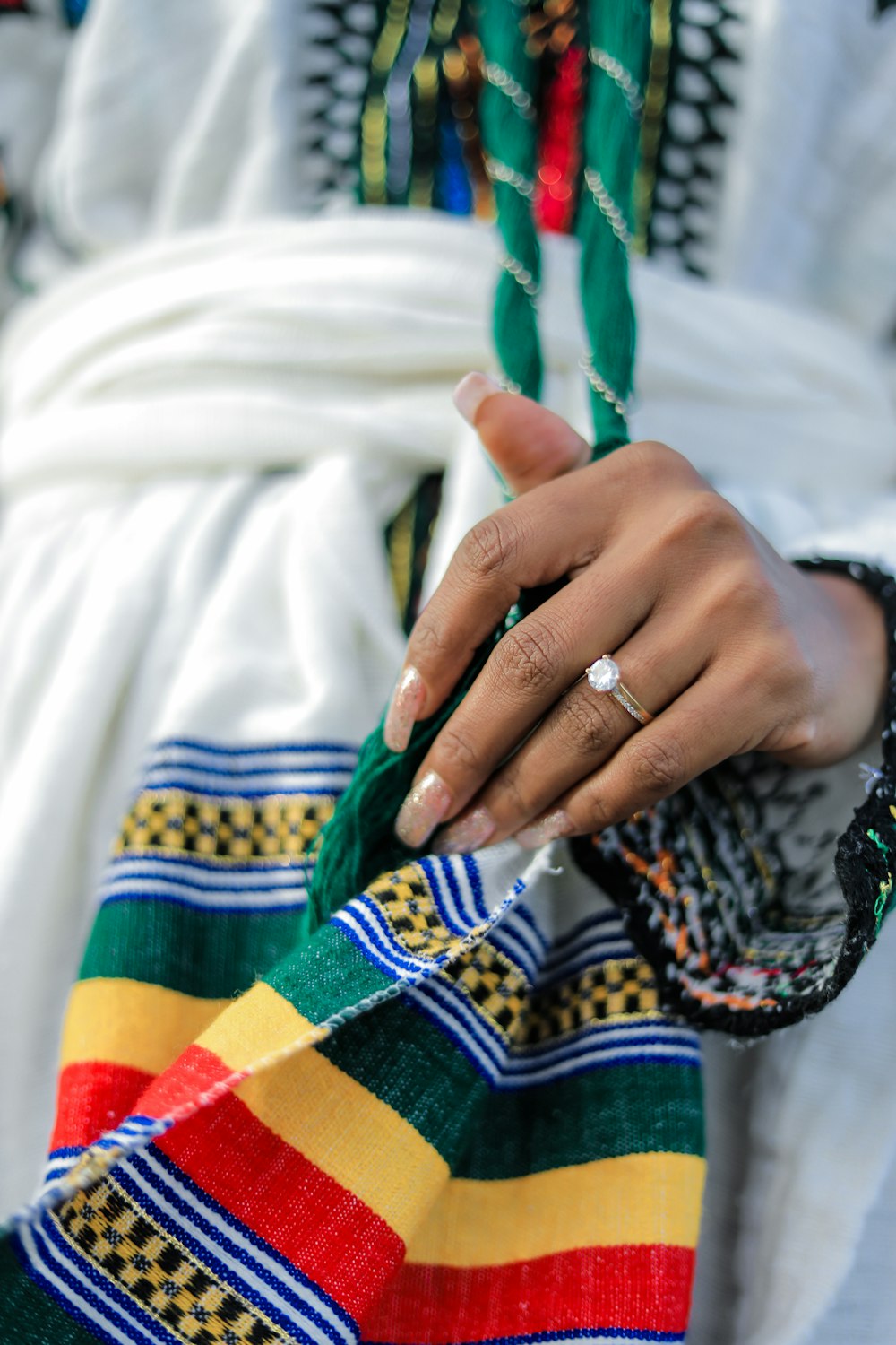 person wearing silver ring and gold ring