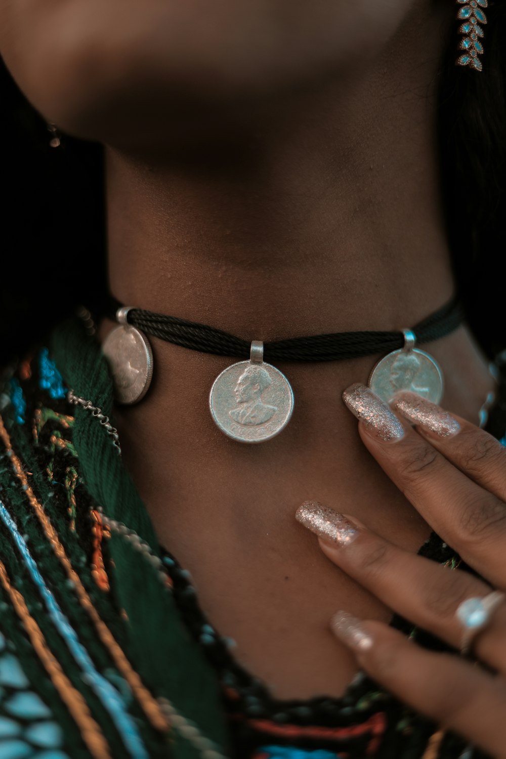 a close up of a person wearing a necklace