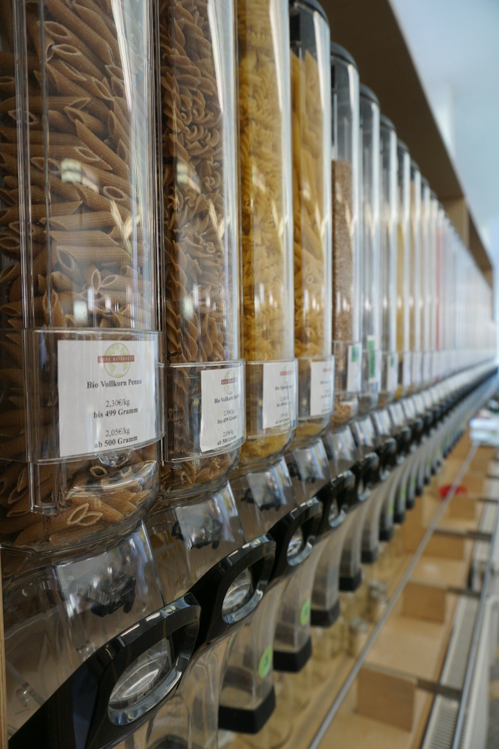 clear glass jars on brown wooden shelf