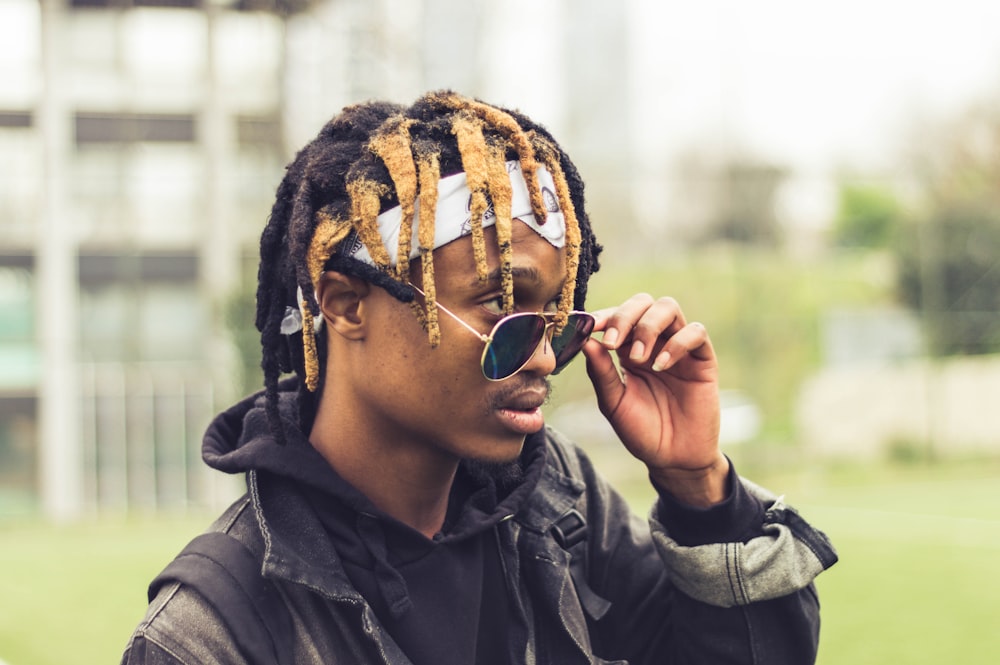 man in black leather jacket wearing black sunglasses